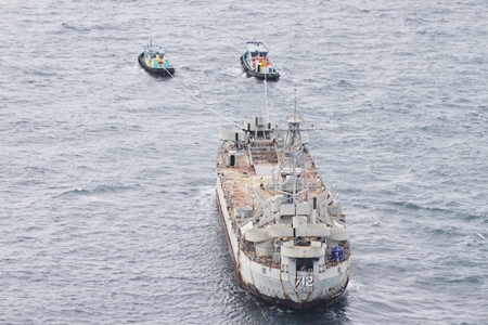 Tugboats tow the HTMS Chang from Bangkok to Koh Chang.